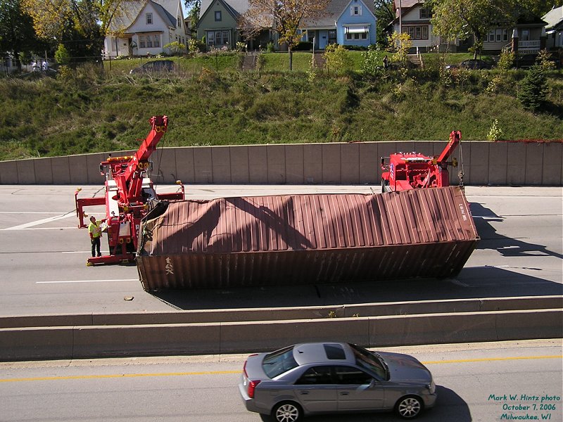 Ray's Towing trucks lifting the fallen container