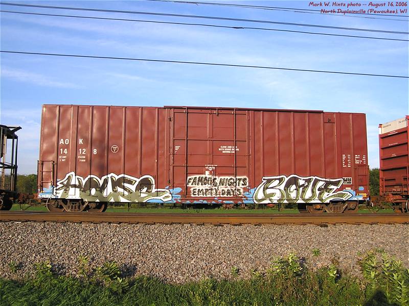 AOK boxcar 14128 with "Famous Nights, Empty Days" graffiti