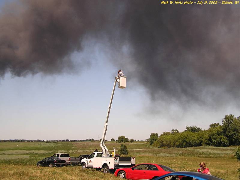 photographer using a cherrypicker to get photos of the Watertown Tire Fire